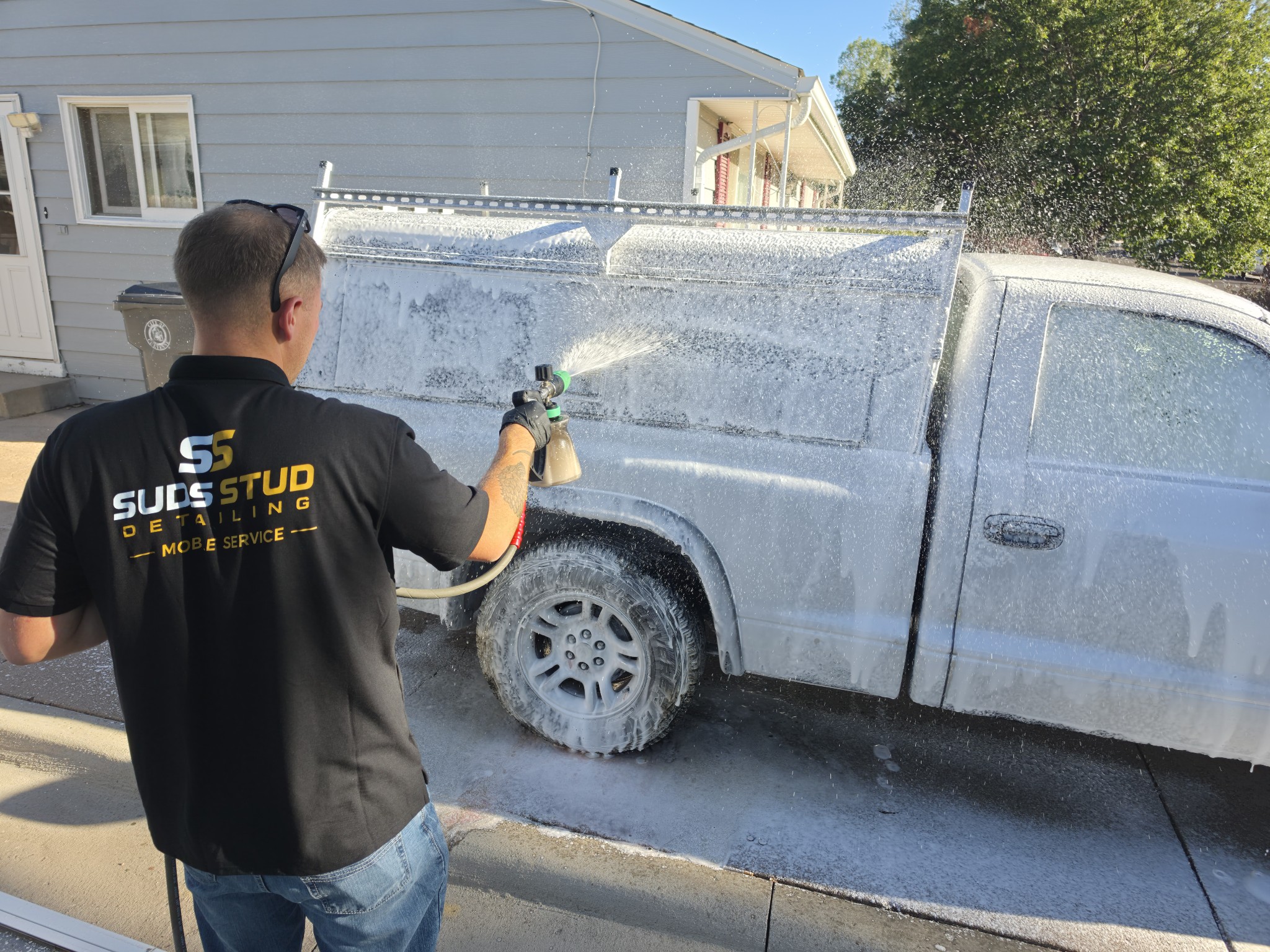 Suds Stud mobile detailing rig set up in a customer driveway